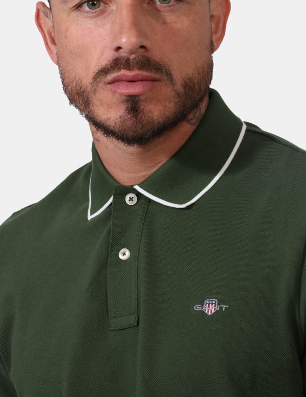 Polo Gant Verde - Polo in fantasia rigata rosa e verde con logo brand ricamato ad altezza cuore. Presente colletto alla pete