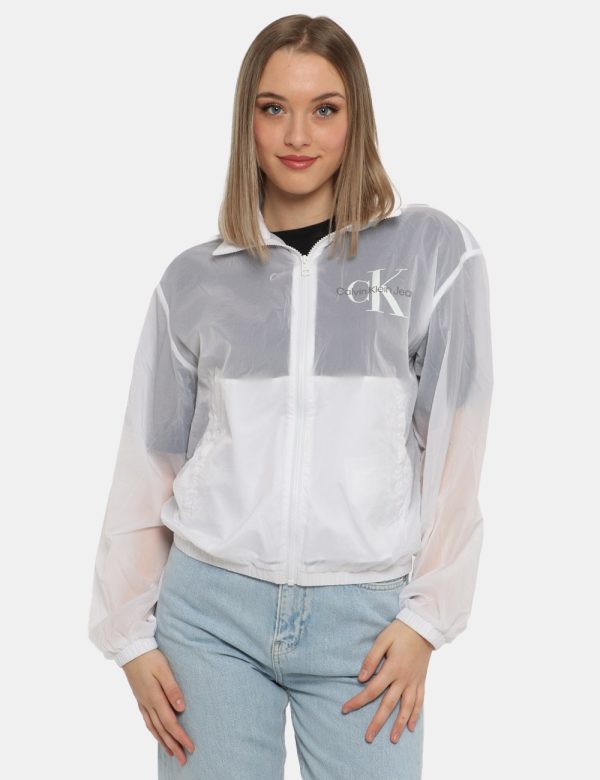 Giacca Calvin Klein Bianco - Giacca leggera simil kway con cappuccio ed in total bianco. Presenti tasche a taglio trasversal