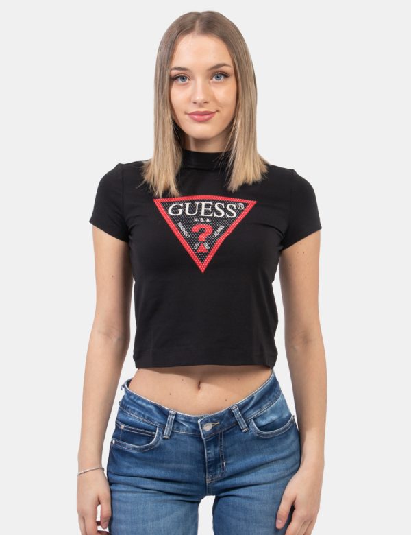 T-shirt Guess Nero - T-shirt corta su base nera con logo brand al centro in bianco e nero e glitter coordinati. La vestibili