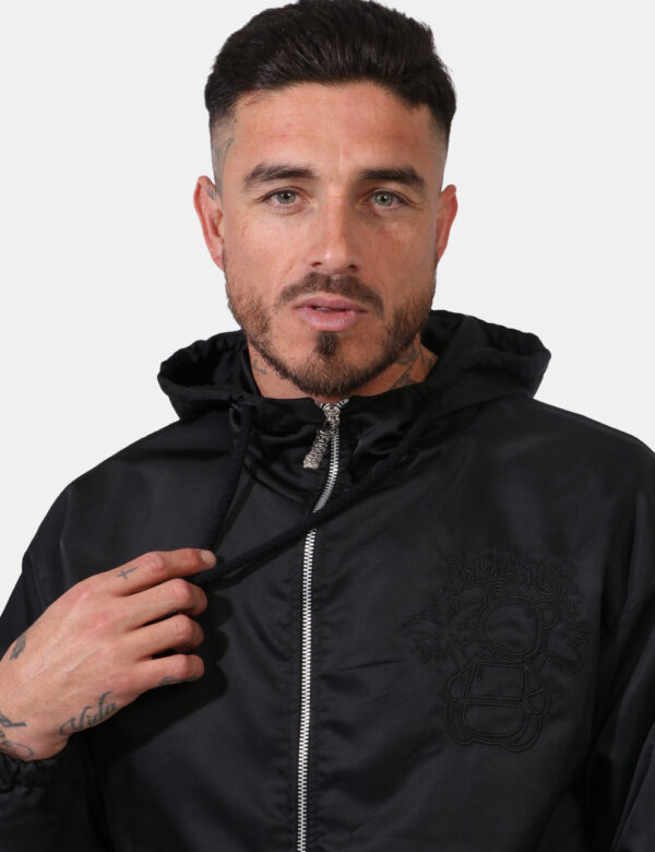 Giacca Disclaimer Nero - Giacca con cappuccio in total nero simil acetato. Presenti tasche a taglio trasversale. La vestibil