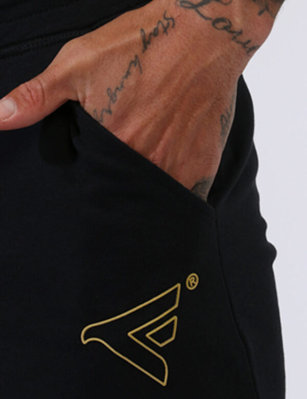 Pantaloni Fred Mello Nero - Pantaloni della tuta in total nero con logo brand giallo. Presenti polsini sul girocaviglia e ta