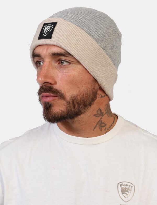 Cappello Blauer Grigio - Cappello modello berretto bicolore grigio e beige con risvoltino e patch nero logo brand. La vestib