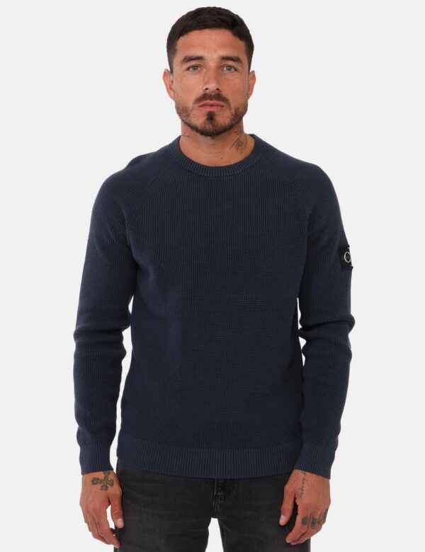 Maglia Calvin Klein Blu - Maglia uomo in total blu/grigiastro con trama lavorata e girocollo classico. La vestibilità è mor