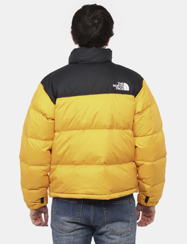 Piumino The North Face Giallo - Piumino bicolor nero e giallo con cappuccio interno. Presenti tasche a taglio trasversale co