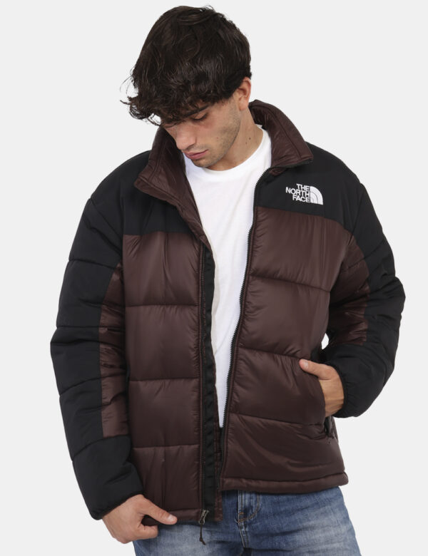 Piumino The North Face Marrone - Piumino bicolor marrone e nero. Presenti tasche a taglio trasversale con chiusura a zip. La