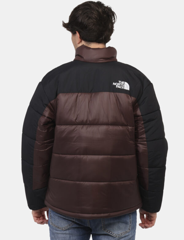 Piumino The North Face Marrone - Piumino bicolor marrone e nero. Presenti tasche a taglio trasversale con chiusura a zip. La