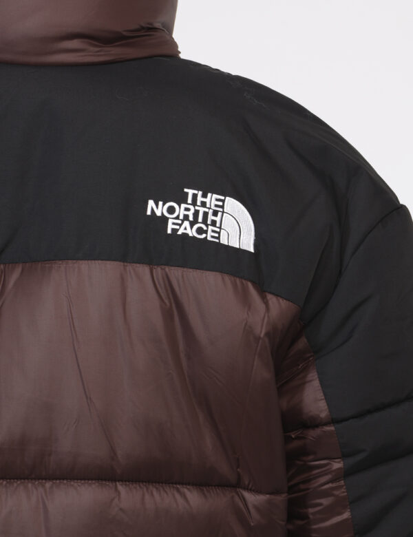 Piumino The North Face Marrone - Piumino bicolor marrone e nero. Presenti tasche a taglio trasversale con chiusura a zip. La