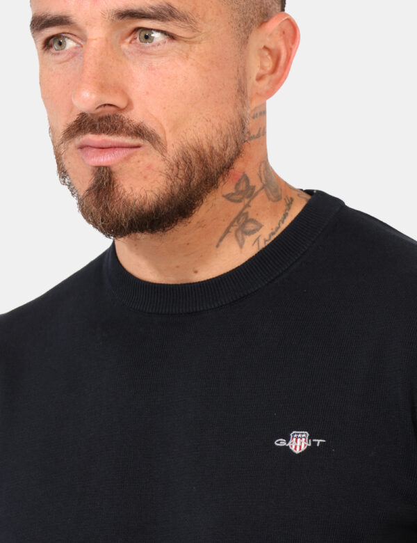Maglione Gant Blu - Maglione classico in total blu navy con patch logo brand ad altezza cuore. La vestibilità è morbida e ab