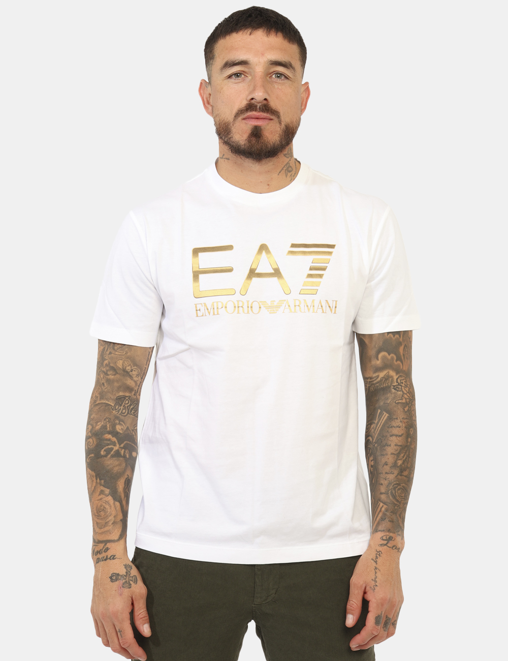 7M001189-AF17789-OA_WHITE_AI25_5 T-shirt EA7 Bianco - T-shirt classica su base bianca con logo brand in oro patinato. La vestibilità è morbida e regolare. La